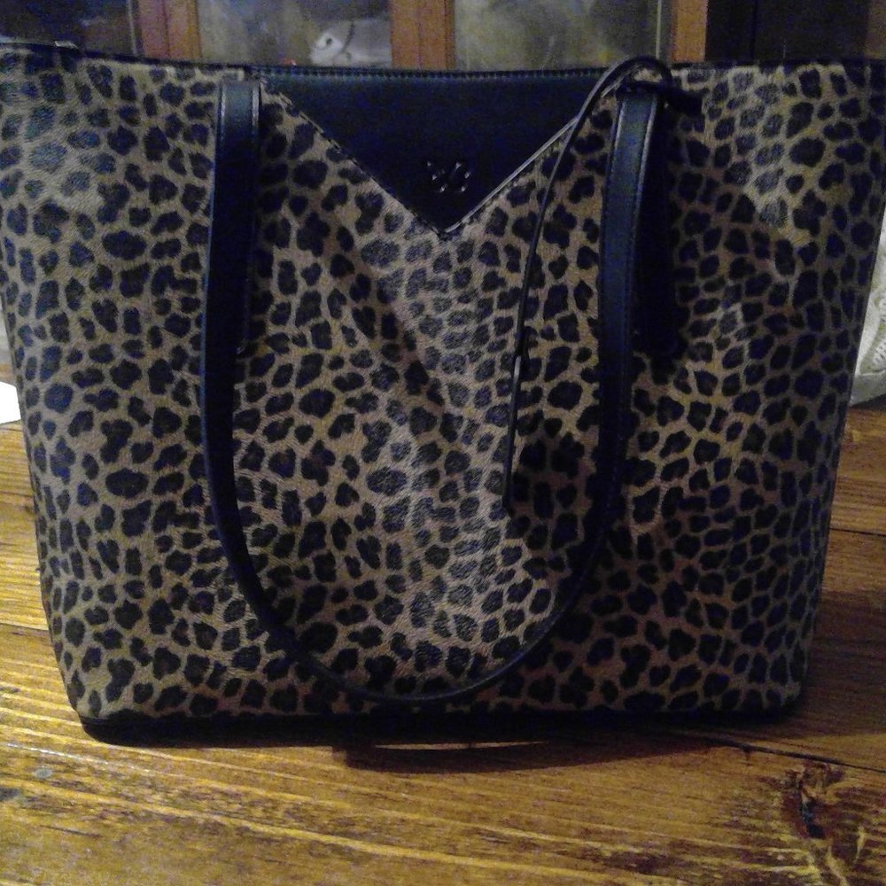 Leopard purse with zip closure.